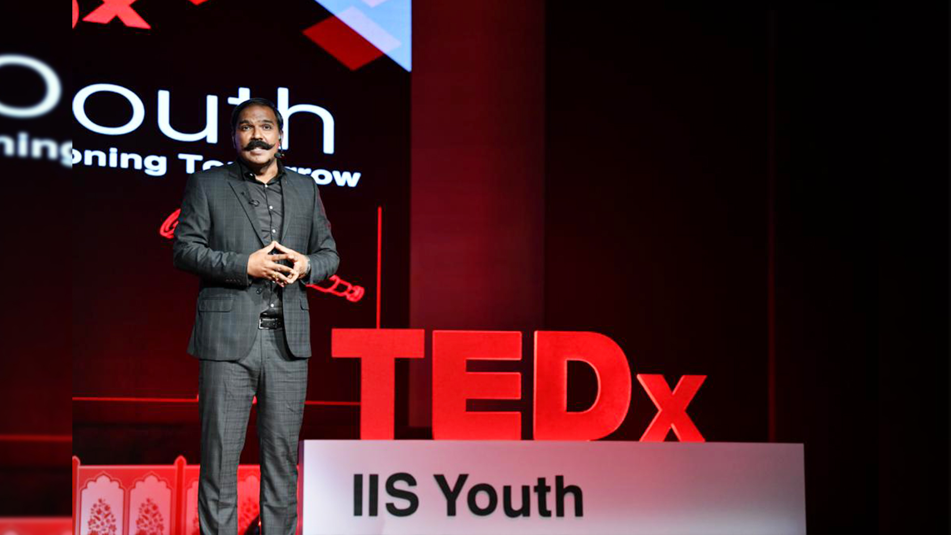 Vikram Sharma on stage delivering an inspiring TEDx talk